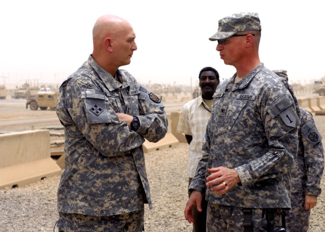 BAGHDAD – Gen. Raymond Odierno (left), commander, Multi-National Force – Iraq, speaks with Col. Joseph Martin, of Dearborn, Mich., commander, 2nd Heavy Brigade Combat Team, 1st Infantry Division, Multi-National Division Baghdad July 7 in front...