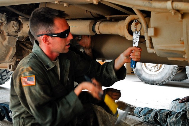 TAJI, Iraq- Spc. Douglas Cordray, from Mansfield, Ohio, utilities equipment repairman, Headquarters Support Company, 615th Aviation Support Battalion, 1st Air Cavalry Brigade, 1st Cavalry Division, Multi-National Division - Baghdad, attempts to...
