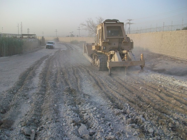 BAGHDAD - A bulldozer operator with the 277th Engineer Company, based in San Antonio completes the ripping process for the reshaping of a roadway on Victory Base Complex.  The dozer uses its digging asset to tear up the roadway to allow for the...