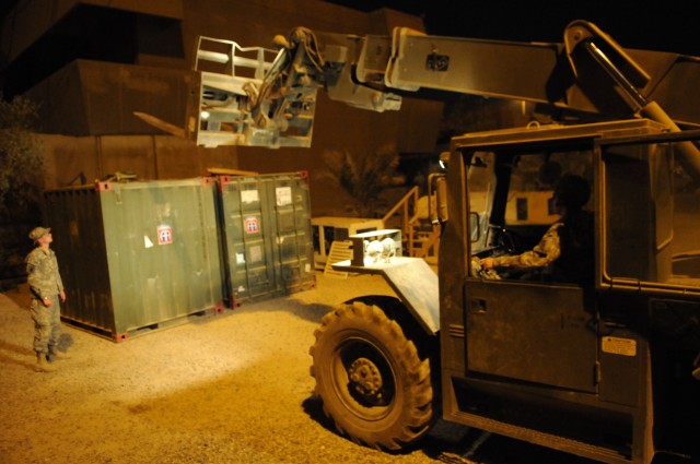 BAGHDAD - Paratroopers assigned to Headquarters and Headquarters Company, 3rd Brigade Combat Team, 82nd Airborne Division, Multi-National Division - Baghdad, use a forklift in order to transport a container full of computer equipment to the Joint...