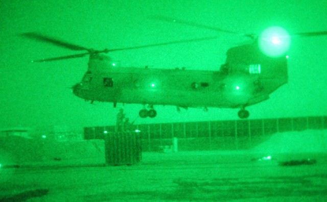 BAGHDAD - Paratroopers assigned to Headquarters and Headquarters Company, 3rd Brigade Combat Team, 82nd Airborne Division, Multi-National Division - Baghdad, prepare a container full of computer equipment for a night time sling load operation July...