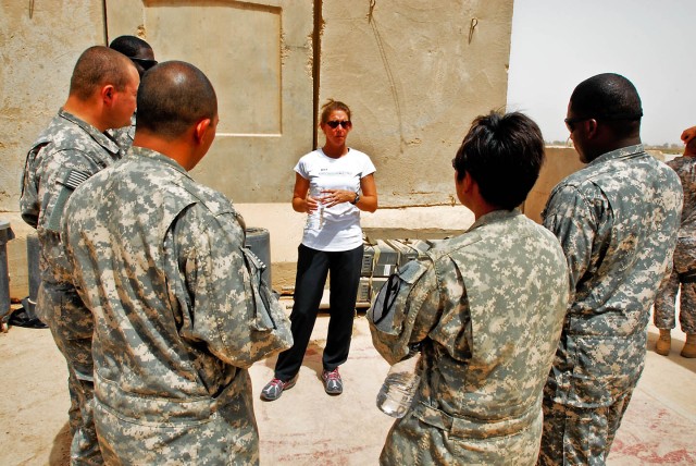 TAJI, Iraq - Sandra Magnus (center), from Belleville, Ill., NASA astronaut, talks about her experiences traveling in space to Soldiers of Company A, 615th Aviation Support Battalion, 1st Air Cavalry Brigade, 1st Cavalry Division, Multi-National Divis...