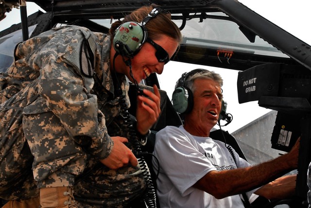 TAJI, Iraq - Frank Shorter (right), from Boulder, Colo., former Olympic gold medalist, shares a laugh with Capt. Laura Parunak (left), from West Jefferson, N.C., Apache pilot Company B, 615th Aviation Support Brigade, 1st Air Cavalry Brigade, 1st Cav...