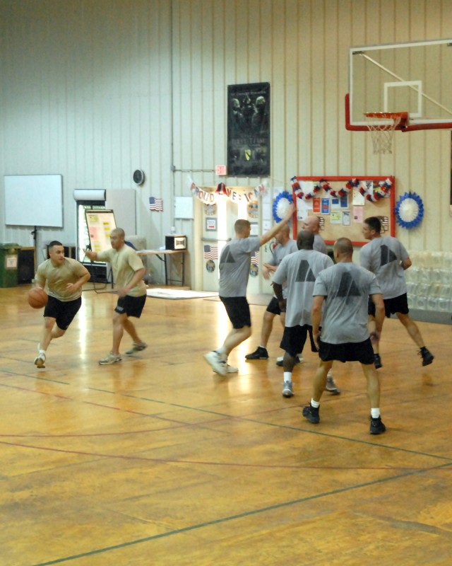 1st Lt. Jason Whitfield, of Baton Rouge, La., covers 1st Lt. Giro Maccheroni, of Staten Island, N.Y., during a game in the division field house, at Camp Liberty. All participants in the game were from the Headquarters Company, 8th Military Police Bri...