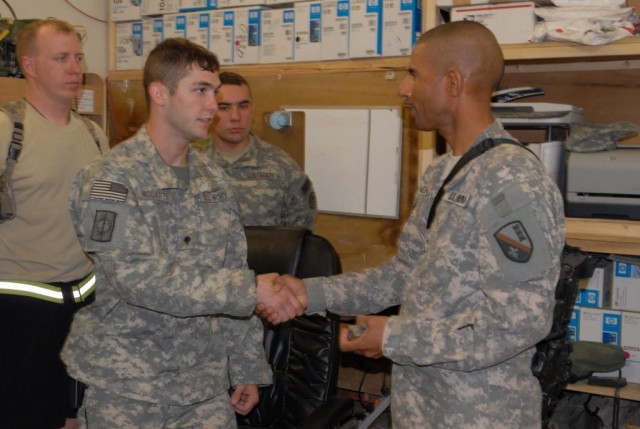 BAGHDAD - Cotton Valley, La. native, Spc. Brent McCarty of the 39th Military Police Company, is greeted by Brig. Gen. Owen Monconduit, commander, 225th Engineer Brigade July 11 during Monconduit's visit to Forward Operating Base Shield. McCarty...