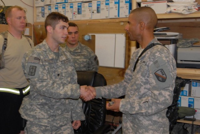 BAGHDAD - Cotton Valley, La. native, Spc. Brent McCarty of the 39th Military Police Company, is greeted by Brig. Gen. Owen Monconduit, commander, 225th Engineer Brigade July 11 during Monconduit's visit to Forward Operating Base Shield. McCarty joine...