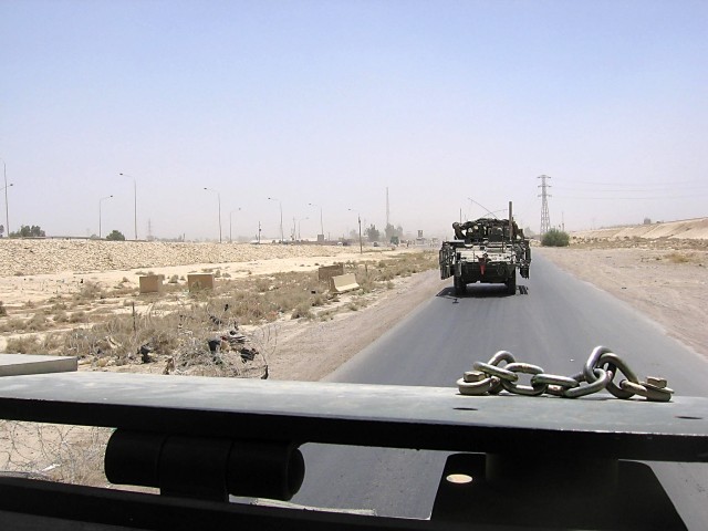 TAJI, Iraq - A Stryker from the 56th Stryker Brigade Combat Team of the Pennsylvania National Guard, Multi-National Division - Baghdad, heads down a road north of Baghdad as seen by Lt. Col. Jeffrey White, the deputy brigade commander, 1st Air...