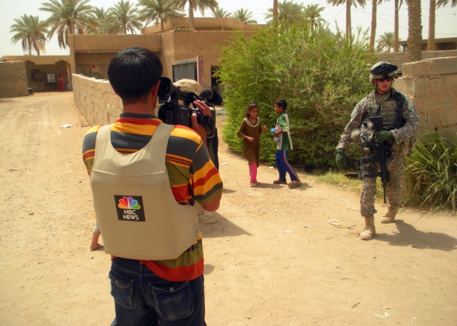 BAGHDAD - A videographer for NBC films Inverness, Fla. native, Capt. Eric Evans, 1st "Dragon" Combined Arms Battalion, 63rd Armored Regiment, 2nd Heavy Brigade Combat Team, 1st Infantry Division during a mission in the Abu Ghraib district west of...