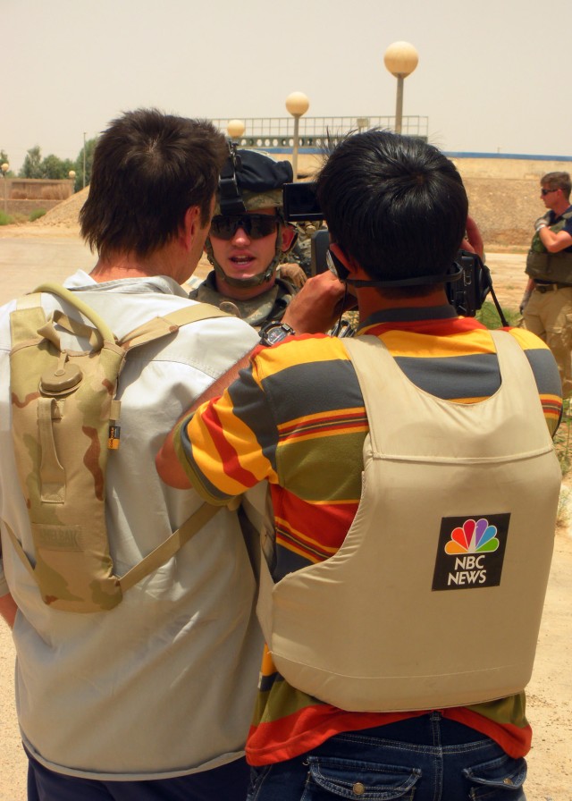 BAGHDAD - Tom Aspell of NBC conducts an interview with Inverness, Fla. native, Capt. Eric Evans, commander, Company A, 1st Combined Arms Battalion, 63rd Armored Regiment, 2nd Heavy Brigade Combat Team, 1st Infantry Division during a mission July...