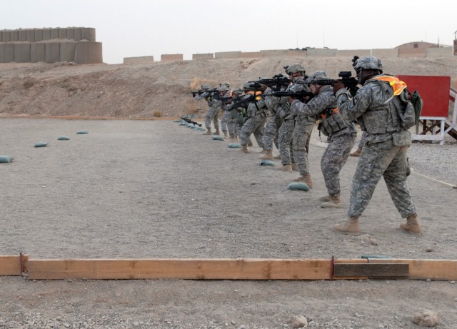 Soldiers fire at paper targets from different positions as part of a competition for both Non-Commissioned Officer and Soldier of the Quarter July 10 on Forward Operating Base Warrior, Kirkuk, Iraq. Soldiers were also expected to be able to treat and...
