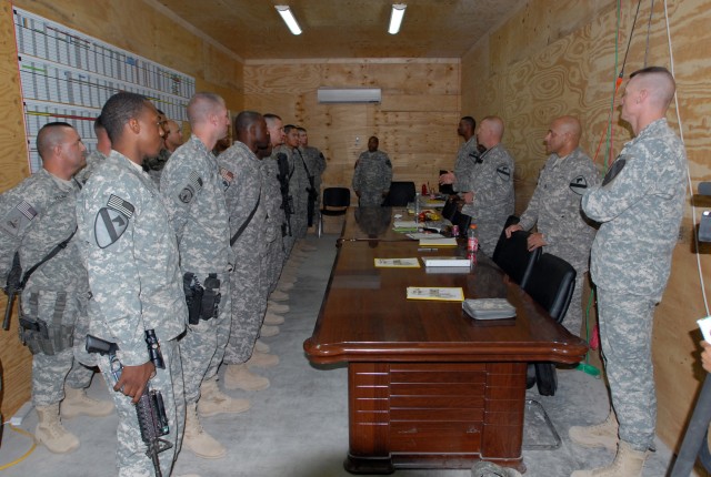 Command Sgt. Maj. Jeffery Hof (third from the front on right side), the top enlisted non-commissioned officer in the 2nd Brigade Combat Team, 1st Cavalry Division, announces the winners of both the NCO and Soldier of the Quarter award on Forward Oper...