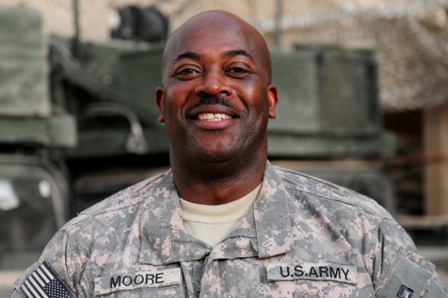 BAGHDAD -- Maj. Calvin Moore, of Ahoskie, N.C., smiles as he talks about his wife, Sharon, and three children, all of whom he misses during his second deployment to Iraq with the 30th Heavy Brigade Combat Team. Moore taught science for 18 years...