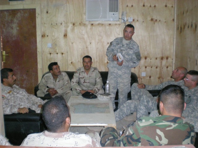 BAGHDAD - Sgt. Heith Kafer, carpentery/masonry specialist, 46th Engineer Combat Battalion (Heavy), 225th Engineer Brigade, of Medford, Ore., briefs construction safety tips to Iraqi and U.S. Soldiers. The 6th Iraqi Army Engineer Regiment Soldiers are...
