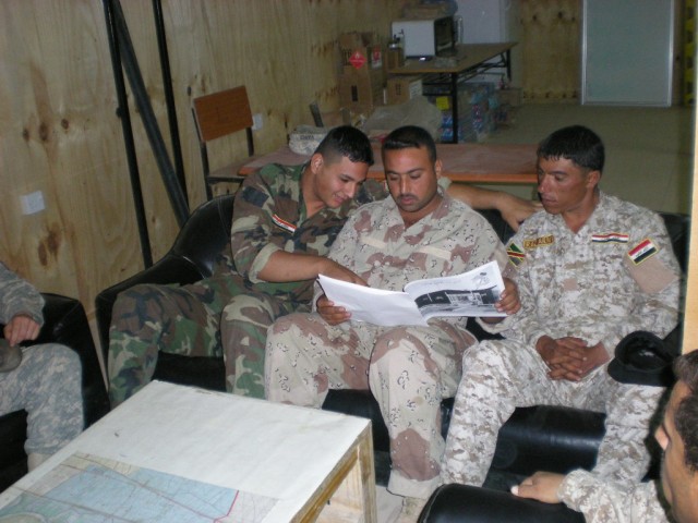 BAGHDAD - Some 6th Iraqi Army Engineer Regiment Soldiers receive training to help build five Army B-huts and safety platforms in five guard towers at Joint Security Station Tarmiyah.  These Iraqi Soldiers are following the safety training instruction...