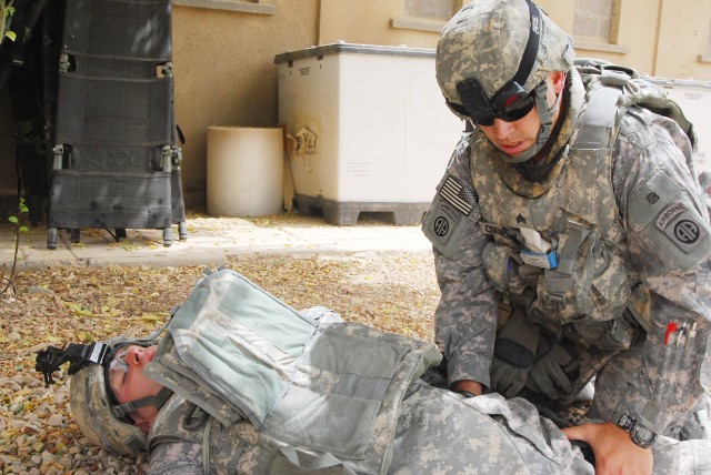 BAGHDAD - Sgt. Jay Councill, of Franklin, Va., a medic assigned to the 2nd Battalion, 505th Parachute Infantry Regiment, 3rd Brigade Combat Team, 82nd Airborne Division Multi-National Division - Baghdad, checks for any additional bleeding on a role-p...