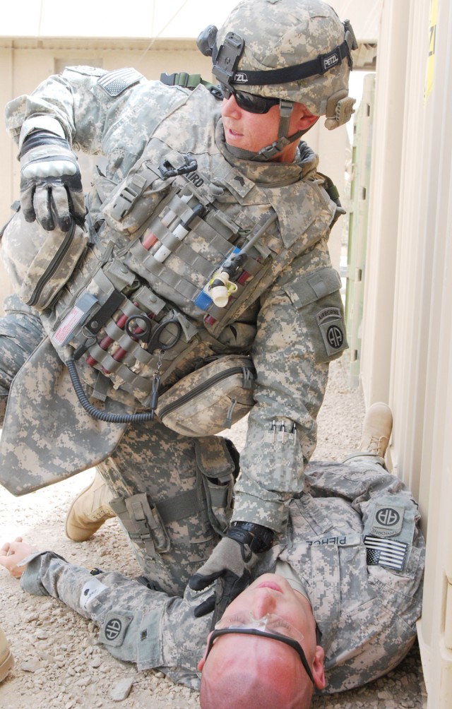 BAGHDAD - Sgt. Scott Baird, of Pigeon Forge, Tenn., a medic assigned to the 2nd Battalion, 505th Parachute Infantry Regiment, 3rd Brigade Combat Team, 82nd Airborne Division Multi-National Division - Baghdad, reaches for his medical pouch in order to...