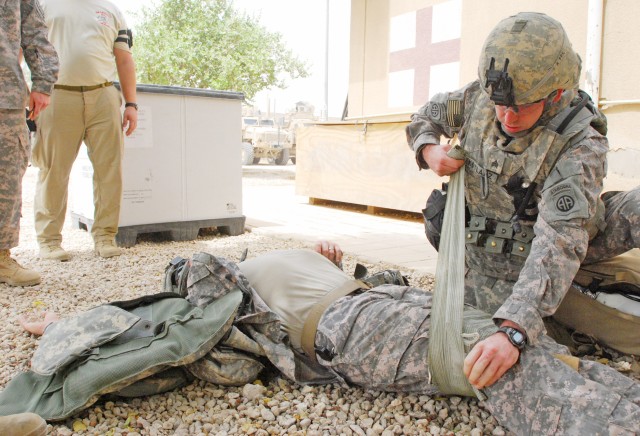 BAGHDAD - Sgt. Braden Kotlarz, of Rockford, Ill., applies a trauma wound dressing on a role-playing wounded Soldier during a trauma lane training exercise July 16 on Joint Security Station Loyalty, located on the 9 Nissan district of eastern Baghdad....