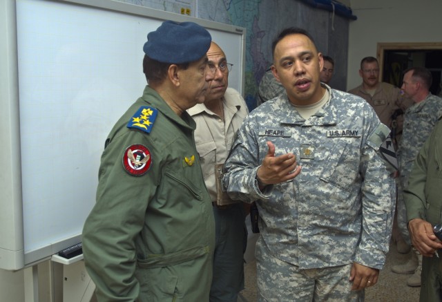 TAJI, Iraq- Maj. Glen Heape (right), from Harker Heights, Texas, operations officer in charge, 1st Air Cavalry Brigade, 1st Cavalry Brigade, Multi-National Division - Baghdad, explains the operations and functions of his section to Brig. Gen. Nazim L...