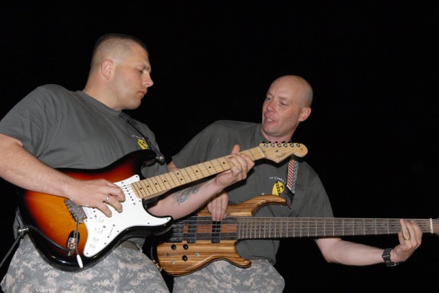 BAGHDAD - Lead guitarist, Sgt. Jason Smelser, from Killeen, Texas, and bass guitarist Staff Sgt. Dennis Milne, a native of Rockford, Ill., both assigned to 1st Cavalry Division Band, Division Special Troops Battalion, 1st Cav. Div., jam together...