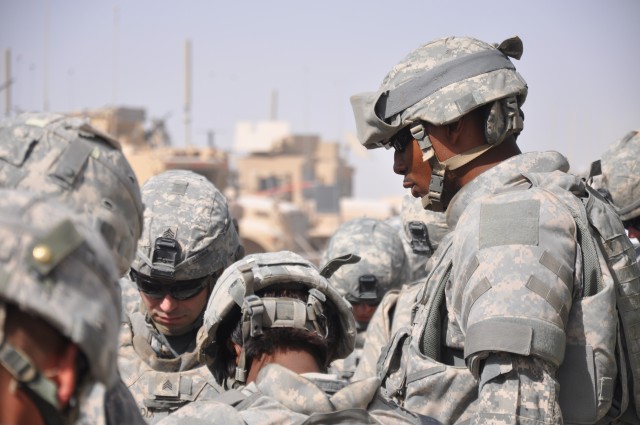 KANDAHAR AIRFIELD, Afghanistan - Sgt. 1st Class Byron T. Mills, a 286th CSSB transportation platoon sergeant from Temple, Texas, prays with Soldiers before leaving on a two day combat logistics patrol to forward operating bases Lagman and...