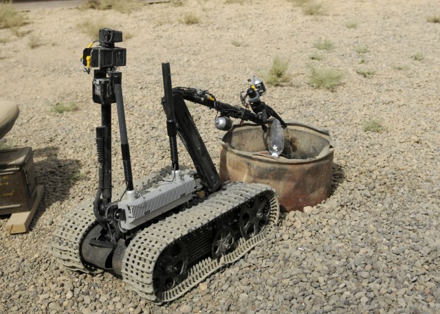 ZAIDAN, Iraq - A remote-controlled robot used by the explosive ordnance team at Combat Outpost Meade, puts a bottle of water in a barrel, showing its abilities. Airman 1st Class Hans Metz with the 447th Explosive Ordnance Disposal team, controlled th...