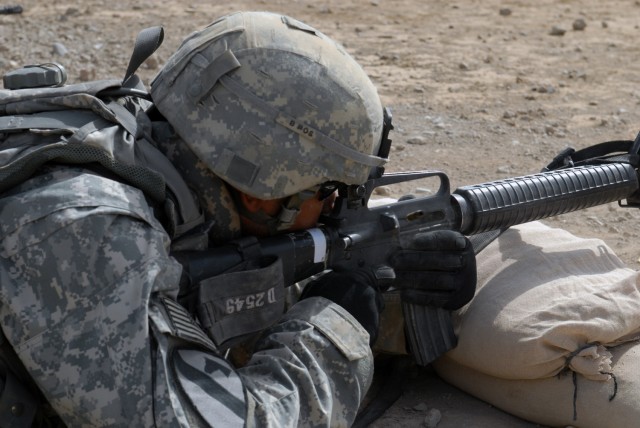 BAGHDAD - Spc. Wilbur DeShields, from Akron, Ohio, assigned to Company A, Division Special Troops Battalion, 1st Cavalry Division, fires at his targets during a zero and qualification range at Caughman Range on Victory Base Complex here, July 17....