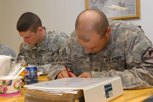 BAGHDAD - Spc. Andrew Lemons (left), an imagery analyst with Company B, Division Special Troops Battalion, 1st Cavalry Division, Multi-National Division-Baghdad, from Houston, and Spc. Cory Elliott, a wheeled vehicle mechanic with Headquarters...