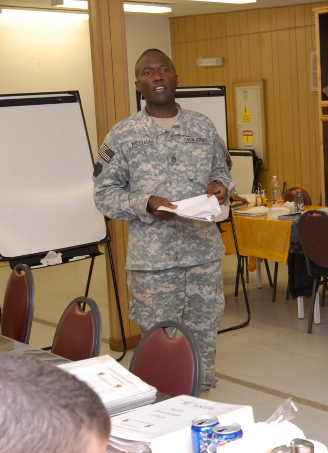 BAGHDAD - Sgt. 1st Class Valroy Williams, an operations noncomissioned officer with the 18th Fires Brigade attached to Company A, Division Special Troops Battalion, 1st Cavalry Division, reviews the answers to the English portion of the final...