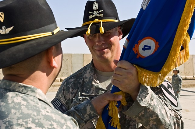 TAJI, Iraq - Command Sgt. Maj. Glen Vela (left) from Dallas, the command sergeant major of the 1st Air Cavalry Brigade, 1st Cavalry Division, Multi-National Division - Baghdad, passes the 4th Battalion, 227th Aviation Regiment, 1st ACB guidon to Comm...