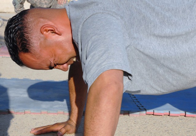 BAGHDAD - Sgt. Noel Zuniga of Aptos, Calif., competes in the push-up event for the Army Physical Fitness Test as part of the Noncommissioned Officer of the Quarter competition for the 225th Engineer Brigade on Camp Liberty, Baghdad July 18. Zuniga wa...