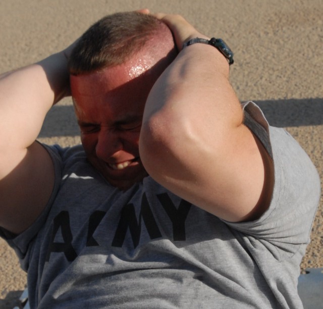 BAGHDAD - Staff Sgt. Joseph Ray of Baton Rouge, La., gives it his all during the sit-up event of the Army Physical Fitness Test as part of the Noncommissioned Officer of the Quarter competition for the 225th Engineer Brigade on Camp Liberty here, Jul...