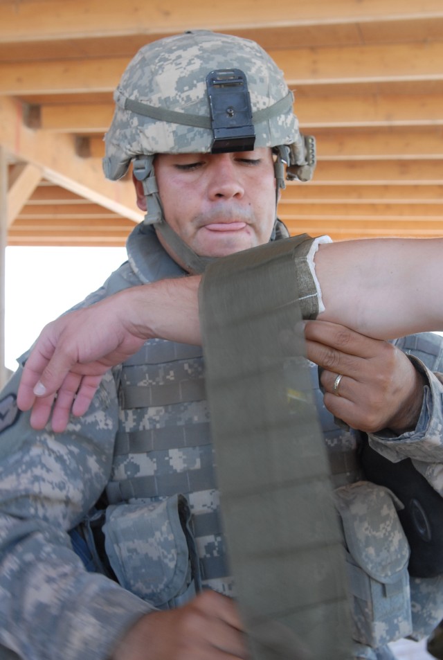 BAGHDAD - Sgt. Noel Zuniga of Aptos, Calif., concentrates on a graded task as part of the Noncommissioned Officer of the Quarter competition for the 225th Engineer Brigade on Camp Liberty July 18. Zuniga said, "I am very proud. This is a big accompli...