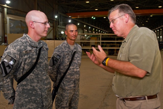 TAJI, Iraq- Missouri Gov. Jay Nixon (right), gestures enthusiastically as he discusses baseball with Sgt. Thomas Adams (center), from St Louis, Mo., transportation coordinator, Headquarters Support Company, 615th Aviation Support Battalion, 1st...