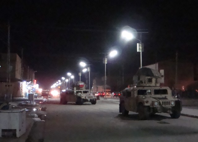 BAGHDAD -Soldiers serving with the 1st Combined Arms Battalion, 18th Infantry Regiment, 2nd Heavy Brigade Combat Team, 1st Infantry Division, Multi-National Division - Baghdad patrol the streets of a well-lit Kadamiyah June 12. The lights...