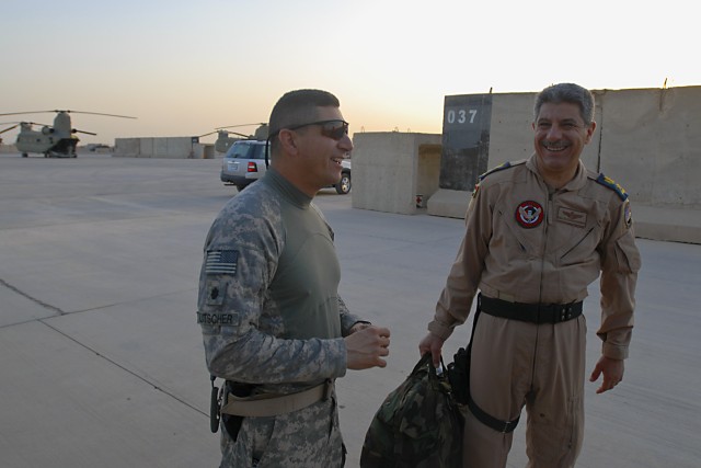 TAJI, Iraq- Lt. Col. Ralph Litscher, from Galf Moon Bay, Calif., commander, 2nd Battalion, 227th Aviation Brigade, 1st Air Cavalry Brigade, 1st Cavalry Division, Multi-National Division - Baghdad, shares a laugh with Lt. Col. Jassim Mohammed, Squadro...
