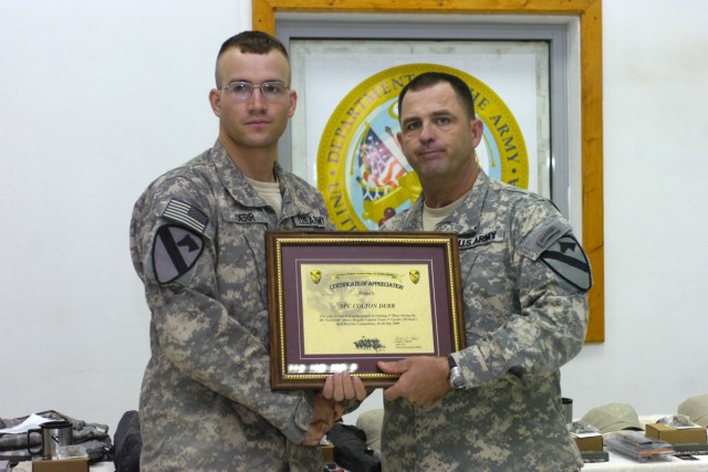 Command Sgt. Maj. James Pippin, the command sergeant major of the 3rd Heavy Brigade Combat Team, 1st Cavalry Division, presents Spc. Colton Derr, the enlisted Soldier representing 6th Squadron, 9th Cavalry Regiment, for being the junior enlisted...