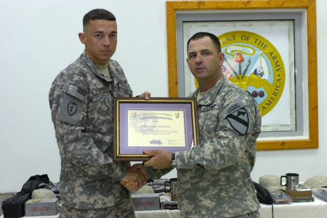 Command Sgt. Maj. James Pippin, the command sergeant major of the 3rd Heavy Brigade Combat Team, 1st Cavalry Division, presents Staff Sgt. Derek Stephens, the NCO representing the 1st Battalion, 67th Armor Regiment for being the NCO winner of the...