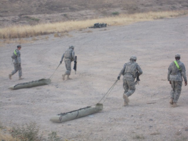 Soldiers from 3rd Brigade Combat Team, 1st Cavalry Division are pulling 100 pound weight litters between firing hills during the Greywolf Best Warrior Competition July 16. The four day competition consisted of a nonstandard physical training test,...