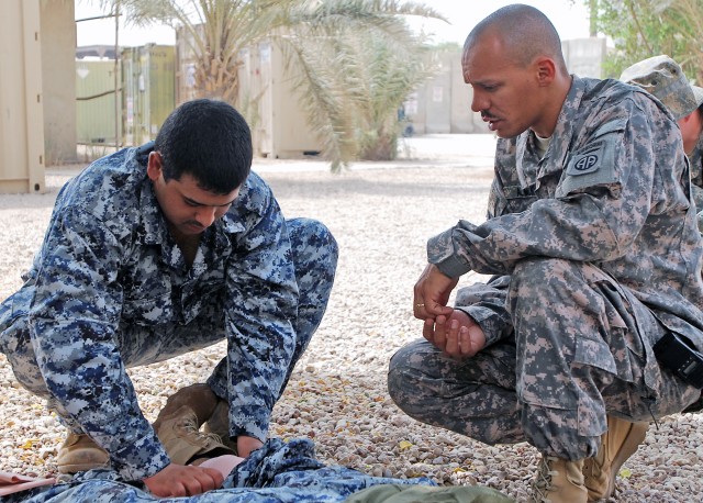 BAGHDAD - Sgt. 1st Class Juan Almonte (right), of New York City, a senior medic assigned to the 2nd Battalion, 505th Parachute Infantry Regiment, 3rd Brigade Combat Team, 82nd Airborne Division, Multi-National Division - Baghdad, instructs a...