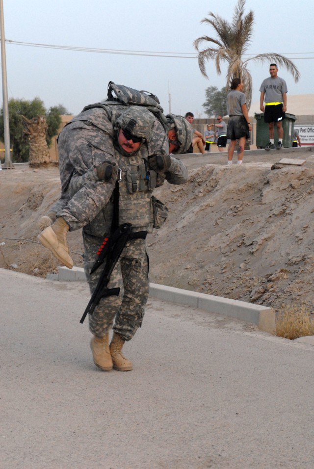 BAGHDAD - Sgt. Andrew Reinheimer of Battery E, 3rd Battalion, 4th Air Defense Artillery Regiment attached to the Division Special Troops Battalion, 1st Cavalry Division, from Radcliff, Ky., transports a 'casualty' during the final training...