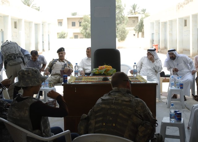 BAGHDAD - Lt. Col. Jim Bradford (right), a native of Lynchburg, Tenn., commander, 1st Combined Arms Battalion, 63rd Armor Regiment, 2nd Heavy Brigade Combat Team, 1st Infantry Division, Multi-National Division - Baghdad, addresses leaders of the...