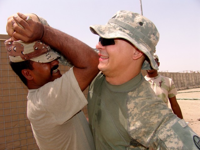 MAHMUDIYAH, Iraq -- Sgt. Brian Kalnicki of Boston a vehicle commander with Headquarters and Headquarters Company, 120th Combined Arms Battalion, 30th Heavy Brigade Combat Team, located in Wilmington, N.C., wrestles with Sgt. Abrams, a Soldier with...