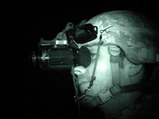 MAHMUDIYAH, Iraq -- Staff Sgt. Stephen Whitley of Jacksonville, N.C., a medic with Company B, 120th Combined Arms Battalion, 30thHeavy Brigade Combat Team, headquartered in Whiteville, N.C., looks for through his night vision goggles on night patrol ...