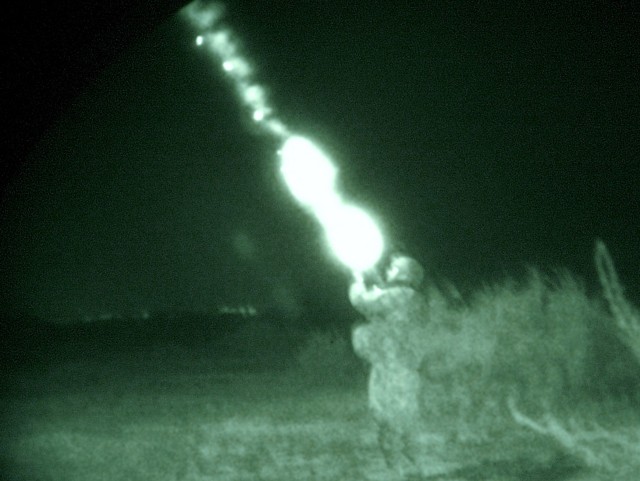 A Soldier with Company B, 120th Combined Arms Battalion, 30th Heavy Brigade Combat Team, headquartered in Whiteville, N.C., fires a flare from his M-203 grenade launcher during a night patrol southeast of Al Dhoura, June 25.  The Soldiers are based o...