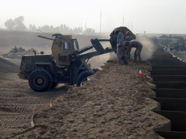 BAGHDAD - Pvt. Nicholas Vickers, heavy equipment operator, Company B, 46th Engineer Combat Battalion (Heavy), 225th Engineer Brigade, a native of  Anderson, Mo., operates a bucker loader to fill HESCO barriers with dirt during range reconstruction at...