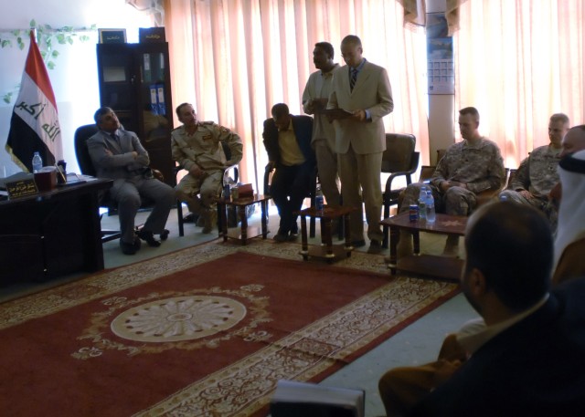 BAGHDAD - Mark Powell, team leader, embedded Provisional Reconstruction Team Baghdad - West, 2nd Heavy Brigade Combat Team, 1st Infantry Division, Multi-National Division - Baghdad, address local government and religious leaders of Abu Ghraib at the ...