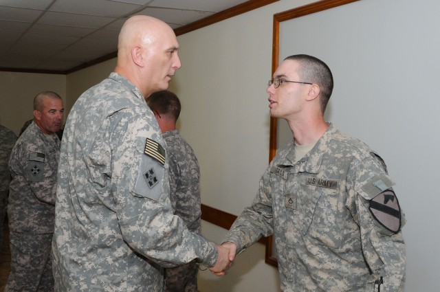 Pvt. 1st Class Christopher Taylor, a native of Cedar Rapids, Iowa, assigned to 1st Battalion, 12th Cavalry Regiment, 3rd Brigade Combat Team, 1st Cavalry Division shakes hands with Gen. Raymond Odierno, Commanding General of Multi-National Forces Ira...