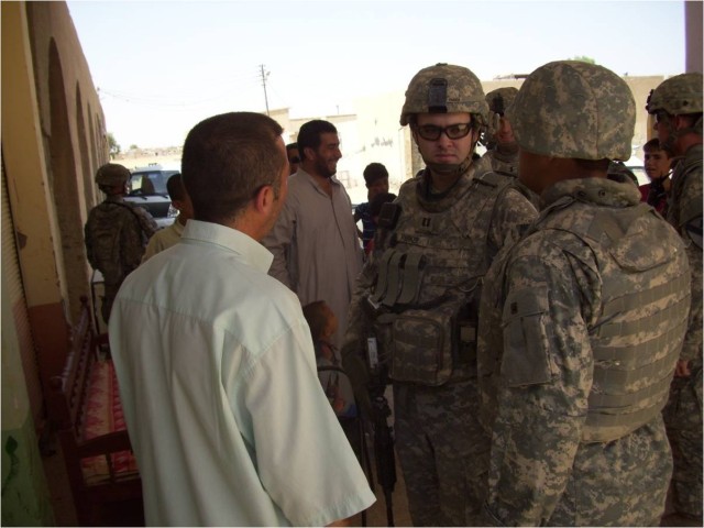 Capt. Joe Parker, a native of Gibson, N.C., and commander of Echo Forward Support Company, 1st Battalion, 12th Cavalry Regiment, 3rd Brigade Combat Team, 1st Cavalry Division talks to a local merchant after he received a microgrant to open a...