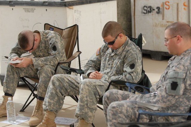 CAMP TAJI, Iraq - Spc. Ryan Koehler (at left) of Oil City, Pa. and Spc. Jared Divittorio (center) of Pittsburgh, both Soldiers with Battery B, 1st Battalion, 108th Field Artillery, 56th Stryker Brigade Combat Team, pray with Staff Sgt. Chris...