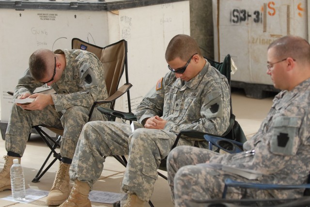 CAMP TAJI, Iraq - Spc. Ryan Koehler (at left) of Oil City, Pa. and Spc. Jared Divittorio (center) of Pittsburgh, both Soldiers with Battery B, 1st Battalion, 108th Field Artillery, 56th Stryker Brigade Combat Team, pray with Staff Sgt. Chris Paulhama...